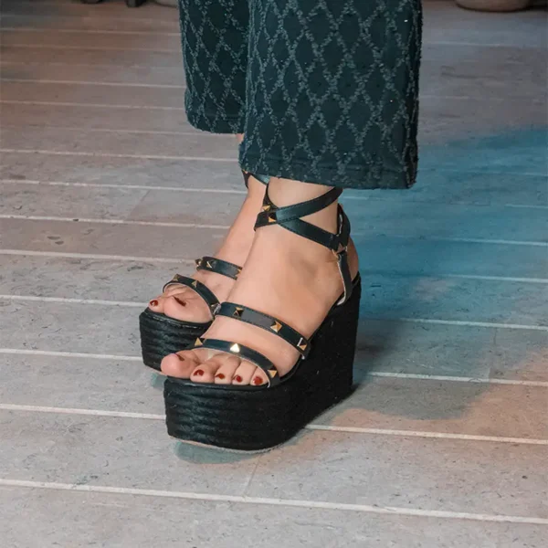 Black platform sandals with a 12 cm high heel and gold details.